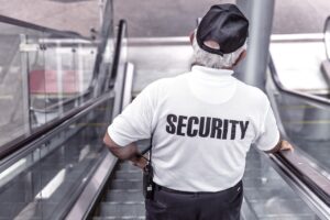Security Guard On Escalator.